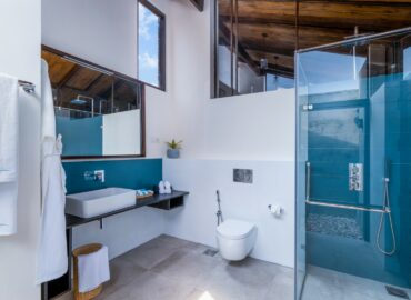 Bathroom arranged with Bathrobes Bath towels and other amenities
