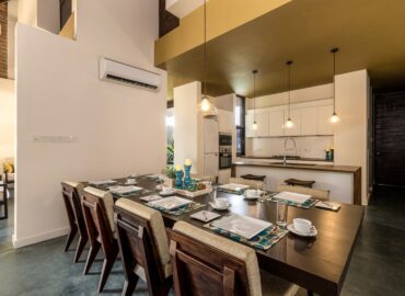 The kitchen area with arranged dining table and chairs