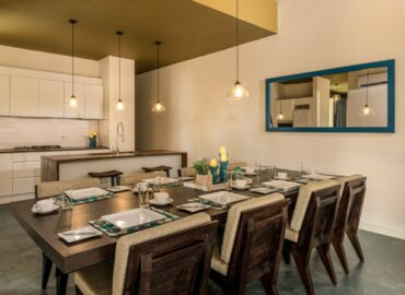 The kitchen area with arranged dining table and chairs