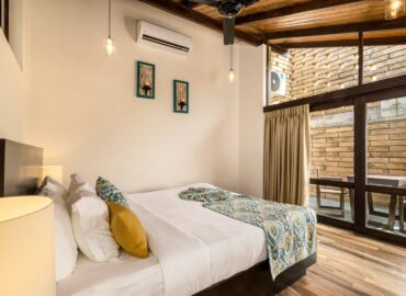 Arranged bed room in the villa with tables in the terrace area